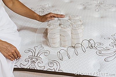 Mattress material in the hands of a woman. Pocket independent spring. Stock Photo