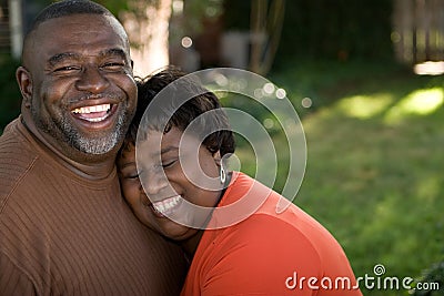 Mature African American couple laughing and hugging. Stock Photo