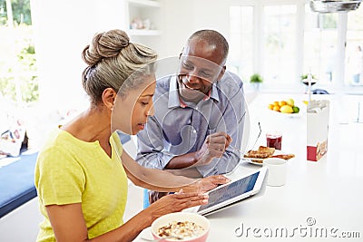 Mature African American Couple Using Digital Tablet At Home Stock Photo