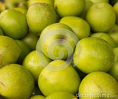 Appetizing green apples on counter in market Stock Photo