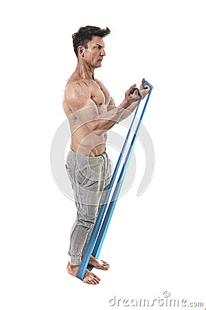 Mature athletic sport man with bodybuilder strong and fit body training doing exercises with elastic rubber band Stock Photo