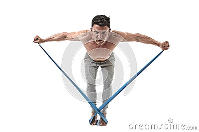 Mature athletic sport man with bodybuilder strong and fit body training doing exercises with elastic rubber band Stock Photo