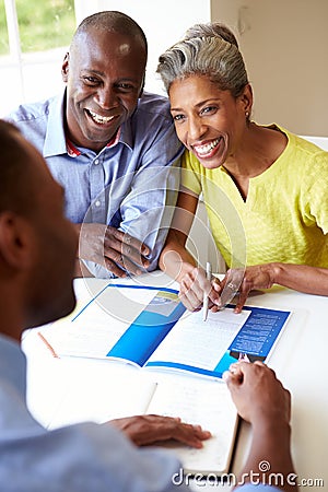 Mature Black Couple Meeting With Financial Advisor At Home Stock Photo