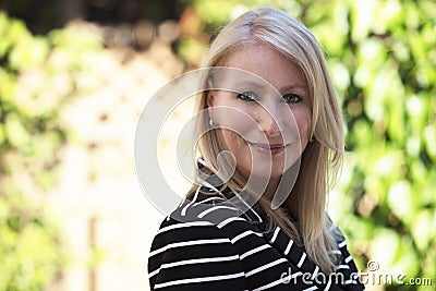 Mature blond woman smiling at the camera. Stock Photo