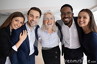 Mature boss company staff members hugging laughing looking at camera Stock Photo