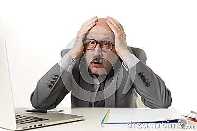 Mature business man with bald head on his 60s working stressed and frustrated at office computer laptop desk looking desperate Stock Photo