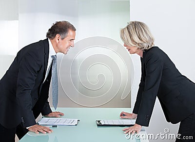 Mature Businessman And Businesswoman Fighting Stock Photo