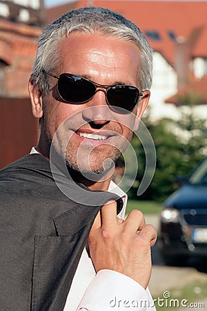 Mature businessman smiling outside Stock Photo