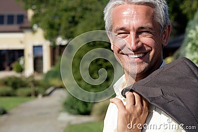 Mature businessman smiling outside Stock Photo