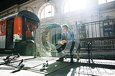 Mature businessman on a train station. Stock Photo