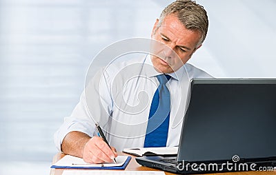 Mature businessman working in office Stock Photo