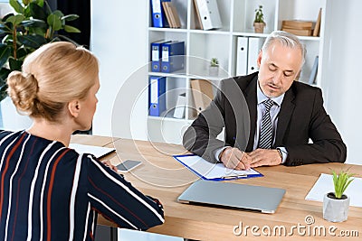 Businessman writing contract with woman Stock Photo