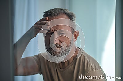 Mature Caucasian male feeling concerned about something Stock Photo