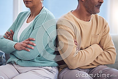 Mature couple, arms crossed or divorce fight on sofa in house or home living room in cheating affair, infidelity or Stock Photo