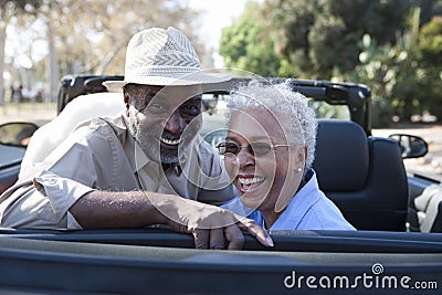 Mature couple at the back seat of car smiling Stock Photo