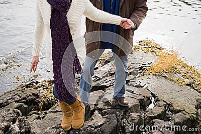 Mature couple climbing rocks Stock Photo