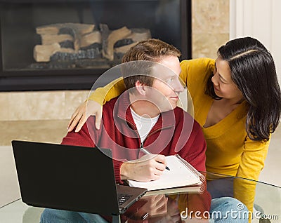 Mature couple displaying pleasure while working from home Stock Photo