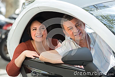 Mature couple driving twizy electric Stock Photo