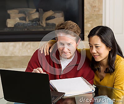 Mature Couple Enjoy working with each other at home Stock Photo