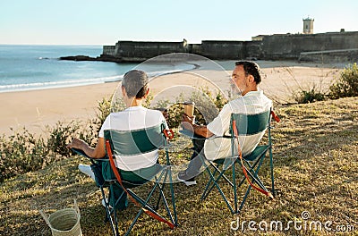 Mature Couple Enjoying Weekend At Ocean Coastline Outdoor, Drinking Coffee Stock Photo