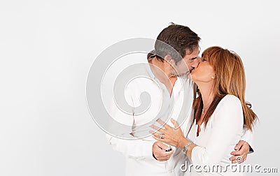 Mature couple giving a kiss during a photo studio session Stock Photo