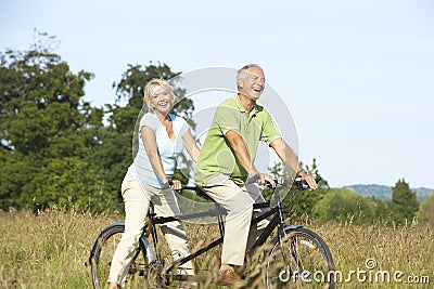 Mature couple riding tandem Stock Photo