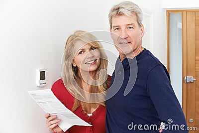 Mature Couple Saving Money On Domestic Heating Bills Stock Photo