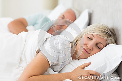 Mature couple sleeping with eyes closed in the bed Stock Photo