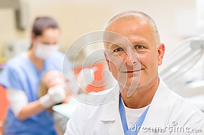 Mature dentist surgeon at office portrait Stock Photo