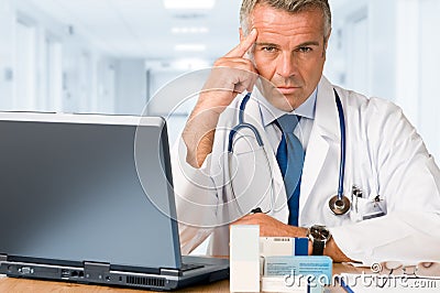Mature doctor gazing at you Stock Photo