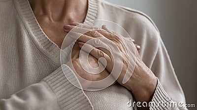 Mature elderly woman feeling heart pain, touching chest Stock Photo