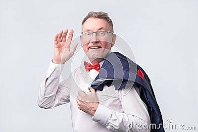 Mature european man in suit wave hand welcome. Stock Photo