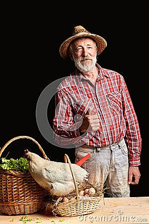 Mature farmer picked up fresh vegetables and eggs, going to sell it to restaurant Stock Photo