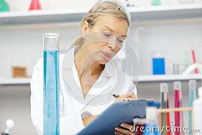 Mature female lab assistant doing scientific experiments in laboratory Stock Photo