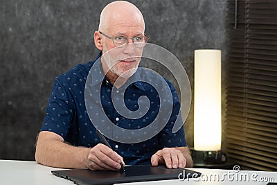 Mature graphic designer using digitized pen Stock Photo