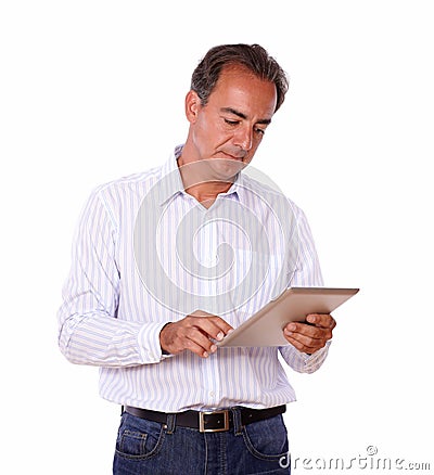 Mature hispanic man using his tablet pc Stock Photo