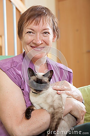 Mature lady holding kitten Stock Photo