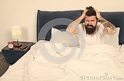 Mature male with beard in pajama on bed. brutal sleepy man in bedroom. asleep and awake. Too early to wake up. energy Stock Photo