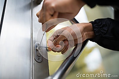 Close-up Of Male Lockpicker Fixing Door Handle At Home Stock Photo