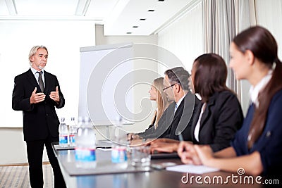 Mature male speaker giving presentation Stock Photo