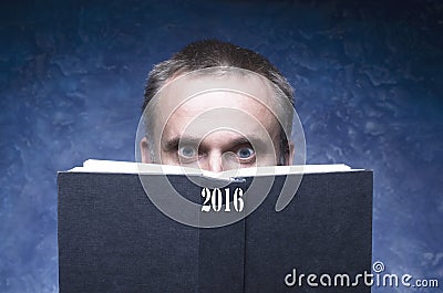 Mature man being focused and hooked by book, reading open book, surprised young man, amazing eyes looking blank cover, 2016 Stock Photo