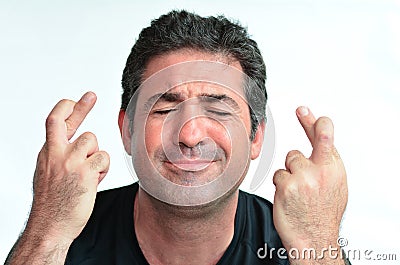 Mature man with crossed fingers hoping for luck Stock Photo