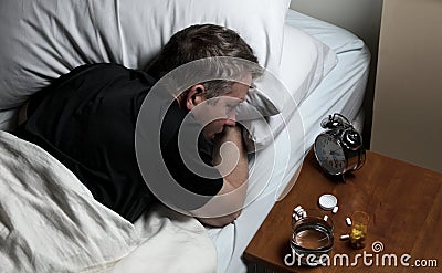 Mature man having difficulty falling asleep at night thus awake Stock Photo