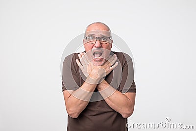 Mature man having terrible pain in throat because of illness. Stock Photo