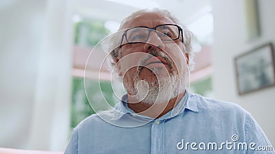 Mature man posing at camera at home. Senior man making surprised emotion Stock Photo