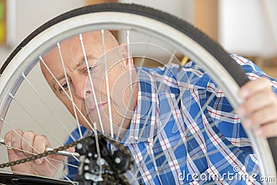 mature man pumping wheel bike Stock Photo