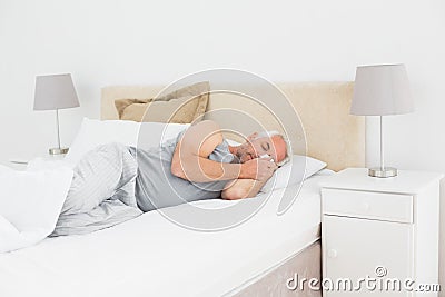 Mature man sleeping in bed Stock Photo