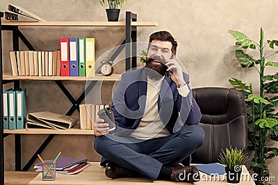 Mature man speak on phone while drinking coffee. business negotiations at coffee break. sharing good news. mobile phone Stock Photo