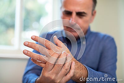 Mature Man Suffering With Repetitive Strain Injury Stock Photo