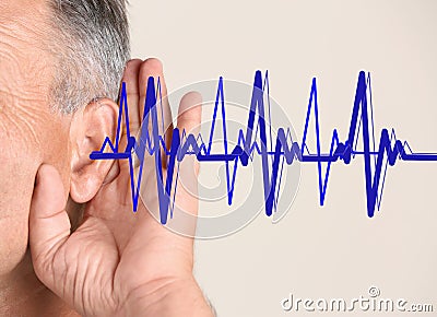 Mature man with symptom of hearing loss Stock Photo